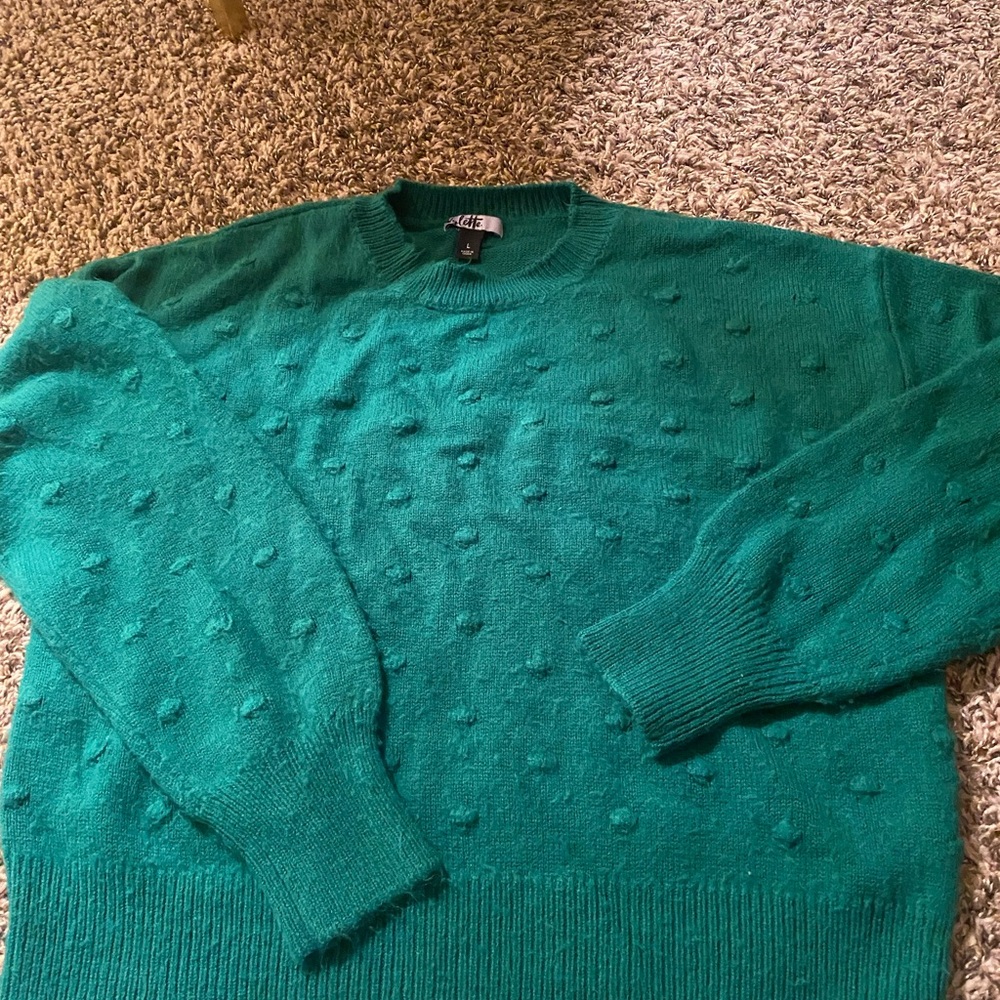 Green sweater with textured polka dots